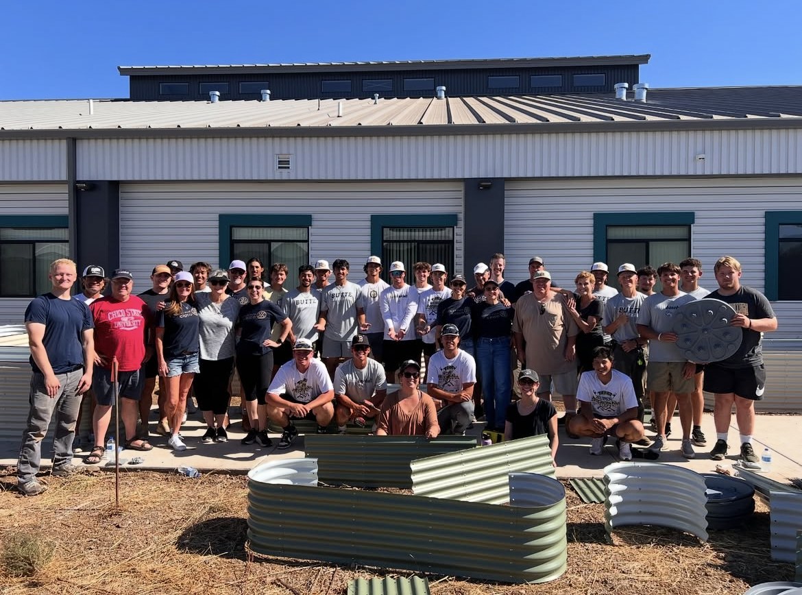 Chico Rotaract members gathered outdoors by garden beds